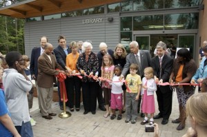 Ribbon-Cutting Community Children as well as those involved in the opening of the new library cut the ribbon.