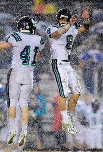 Braxton Berrios (#8) and Max Reconnu (#41) celebrate a big play as the rain pours down at Millbrook. Berrios scored Leesville's only touchdown in a 7-3 win.