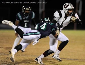 Evan Braband, Wakefield quarterback, fights to escape a tackle from Mike Dehaney, Leesville junior. Brabrand's heroics led the Wolverines to a stunning 34-31 win over the host Pride in the Cap-8 championship.