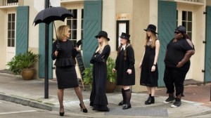 In this scene of Coven, Fiona Good (Jessica Lange) leads the girls from Miss Robichaux's Academy for Exceptional Young Ladies through downtown New Orleans to show them historical sites that pertain to witches. The characters from left to right are Madison Montgomery (Emma Roberts), Nan (Jamie Brewer), Zoe Benson (Taissa Farmiga), and Queenie (Gabourey Sidibe).