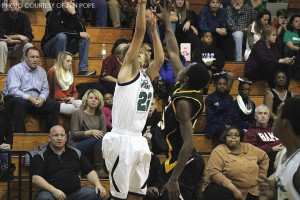 Sanders Rohs, senior (#22), attempts a three-point shot over an Apex defender during the first half. Sanders went on to record a team-high 18 points as Leesville won 47-43.