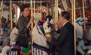 A photo captured from a scene in Saving Mr. Banks in which Walt Disney (Tom Hanks) coerces P.L. Travers, (Emma Thompson) the reclusive author of Mary Poppins, to ride on a  Merry go round at Disney World. Saving Mr. Banks illustrated the real-life story of Walt Disney’s pursuit to make Marry Poppins a movie.