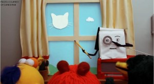 The notebook from “Don’t Hug Me I’m Scared” holds a magnifying glass to its eye in order to show the puppets the “correct” way to look at the clouds. This particular scene illustrates the media manipulation in children’s shows which promote a certain point of view.