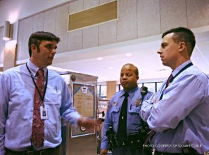 Mr. Price, far left, converses with Deputy Greene and Dr. Muttillo.