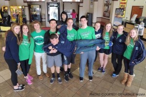 The Pride Swimming and Diving team cheerfully gather for a picture outside the Triangle Aquatic Center. The team made an impressive mark during CAP-8 and 4-A East Regionals.