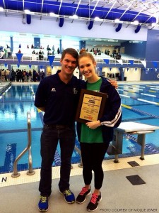 Mollie Jewett, senior, celebrates with Coach Kyle Myers after the swimming team’s first-place finish at the CAP-8 conference championships. Jewett swam the 50 and 100 yard freestyle medley.