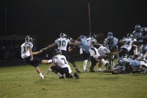 Taylor Johnson, senior kicker, attempts a field goal that is blocked by a diving Panther Creek player.