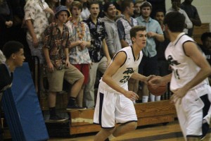 Ben Zemonek (#23) dribbles the ball during the first half of Tuesday's game while Cory Subasic (foreground) looks back. Zemonek led Leesville with 21 points, all of which were from the field.